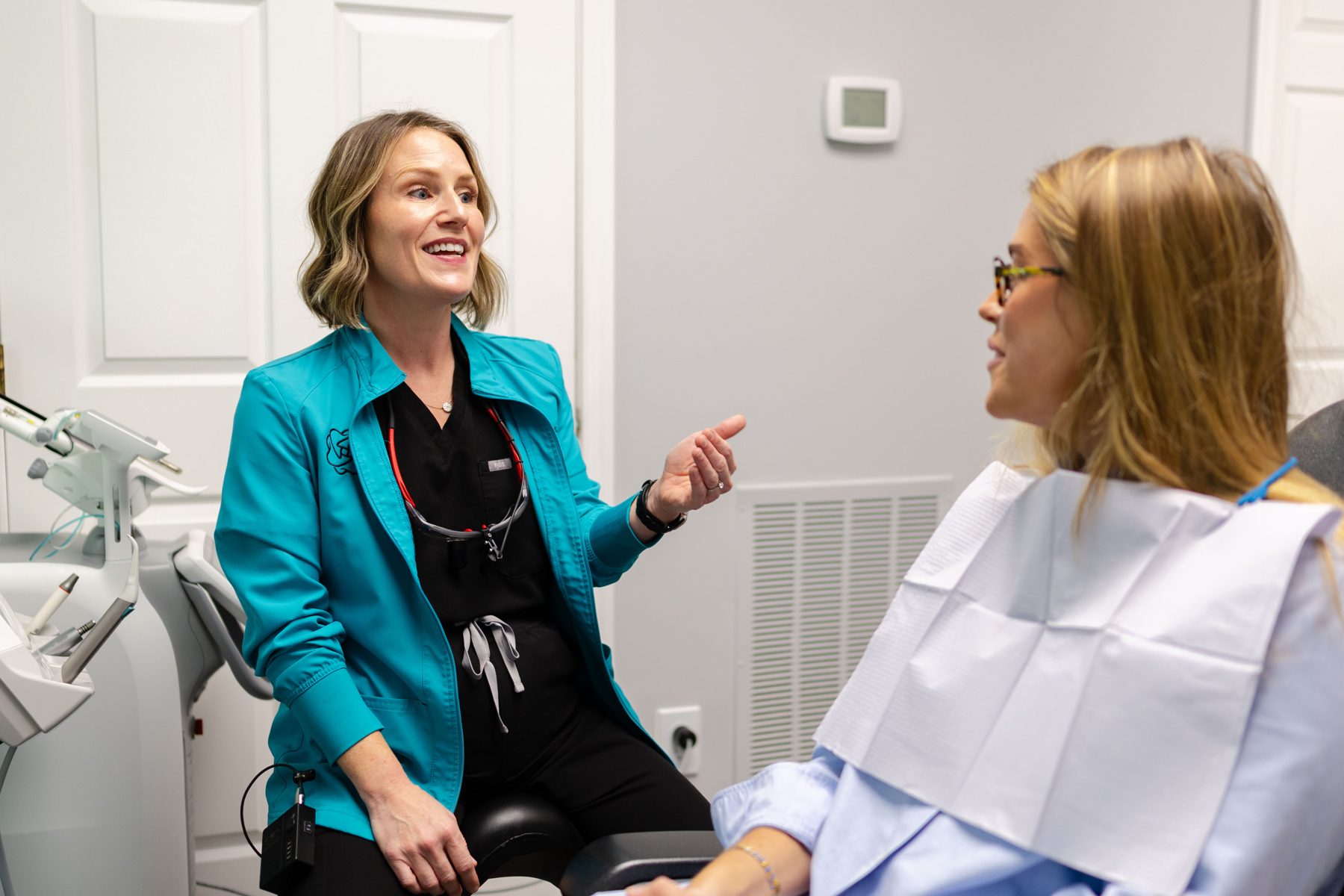 Dr. Hulver talking with a patient in a treatment room at Metropolitan Dental Centre