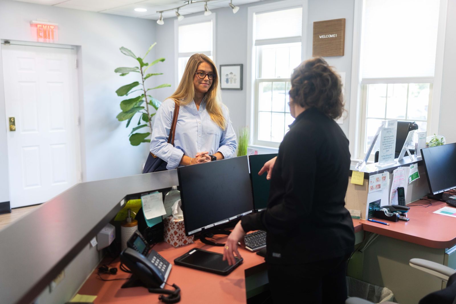 Front desk team talking through payment with a patient