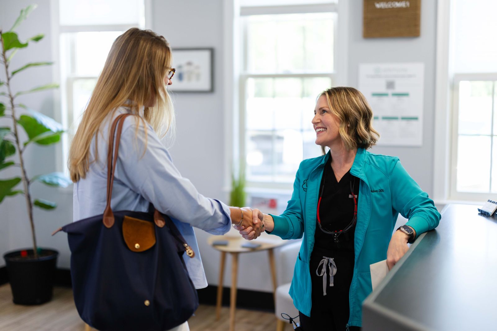 Front desk team member welcoming a patient at Metropolitan Dental Centre