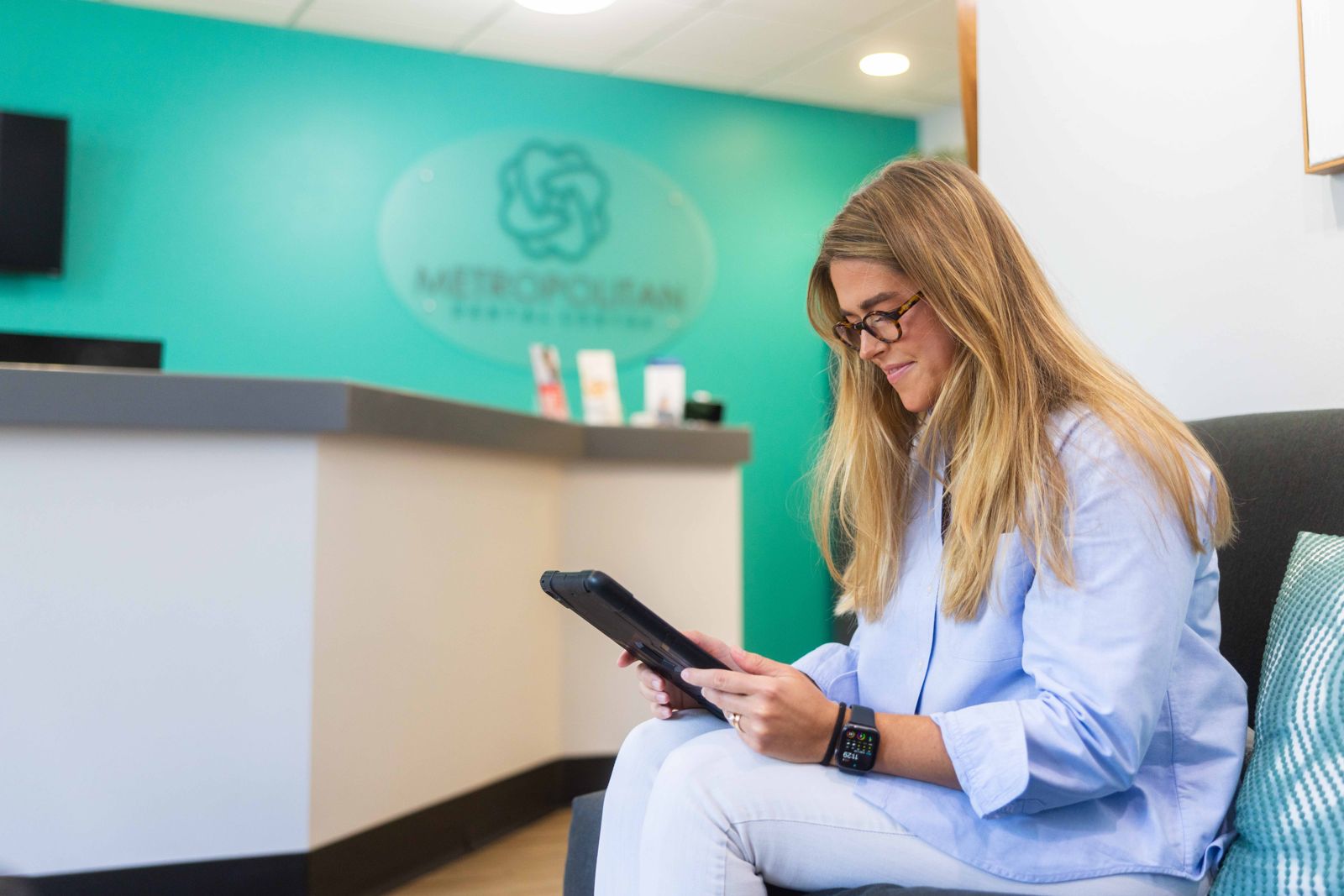 New patient completing forms on a tablet at Metropolitan Dental Centre
