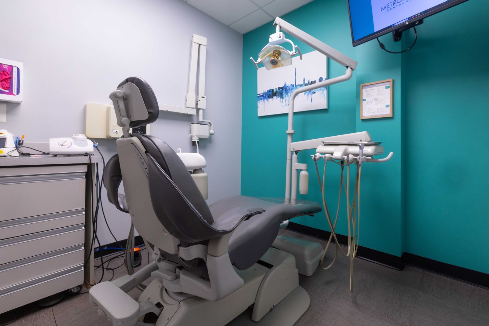Treatment room with patient chair at Metropolitan Dental Centre